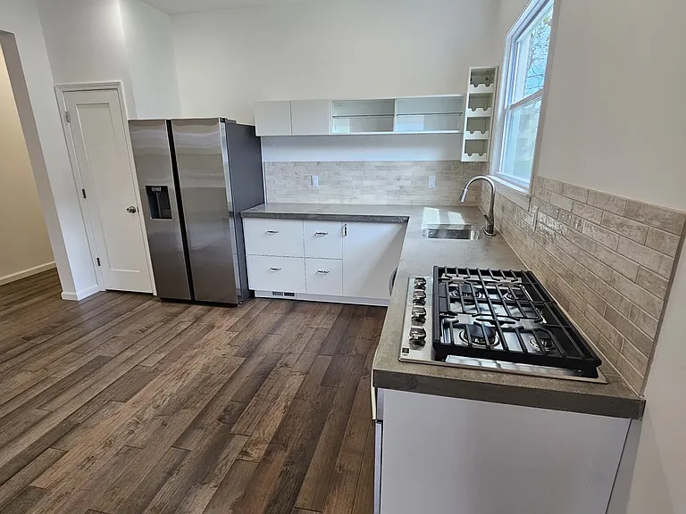 kitchen cabinets, appliances, concrete countertop, pantry closet
