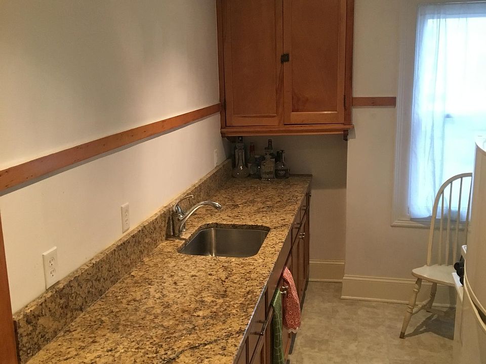 Updated, eat-in kitchen with granite countertop and custom made cabinets.