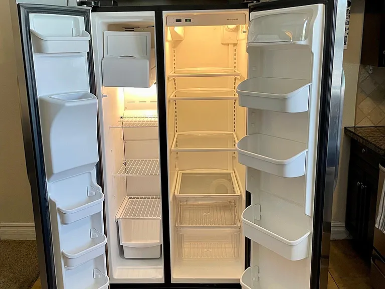 Double door fridge features ice maker and plenty of space for fridge/freezer foods