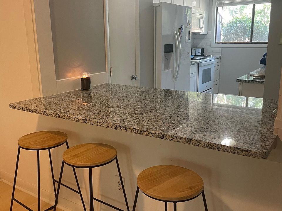 Snack bar with spacious granite countertop and seating for 3.