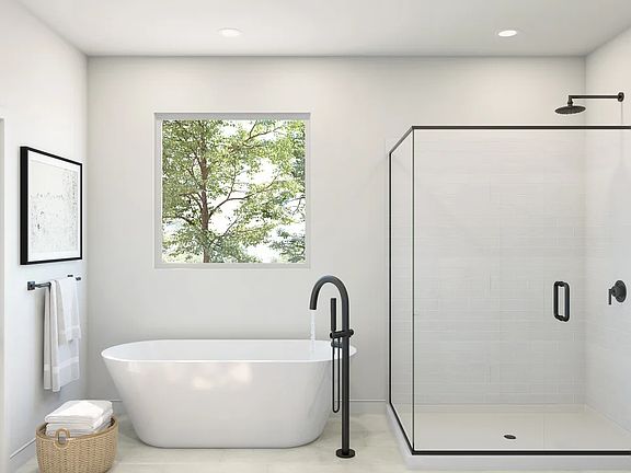 Primary bath with freestanding vanity and glass shower enclosure