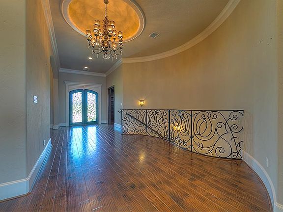 ou enter from ground level to the main living areas, kitchen, dining, study & master. Dazzling custom Iron takes you Downstairs to a central game area, a media room wired for your custom equipment, 2 bedrooms with private baths & an exercise area.