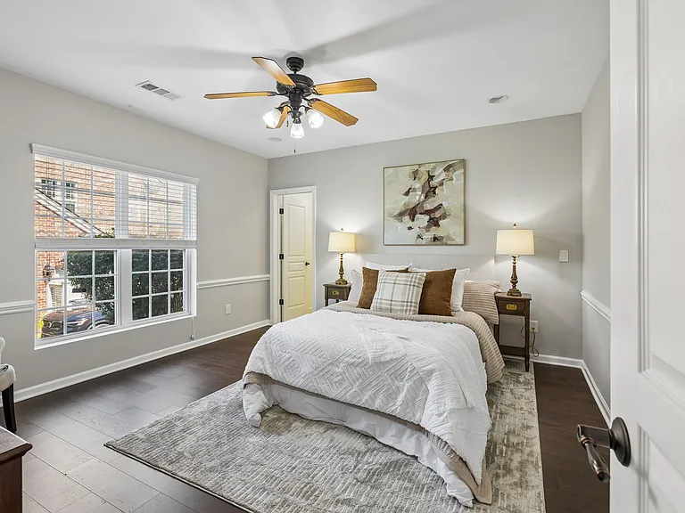 The walkout lower level also includes a spacious guest bedroom with wood flooring, walk-in closet, abundant natural light, and a full bath providing the perfect retreat for overnight guests, teens, or multi-generational living.