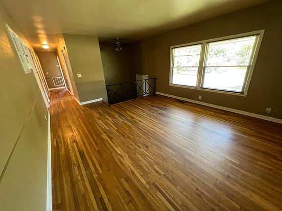 Another view of the living area showing entrance and hallway to bedrooms and bath.