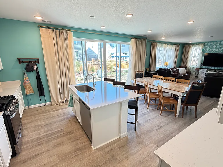 Open concept kitchen, dining, and living rooms