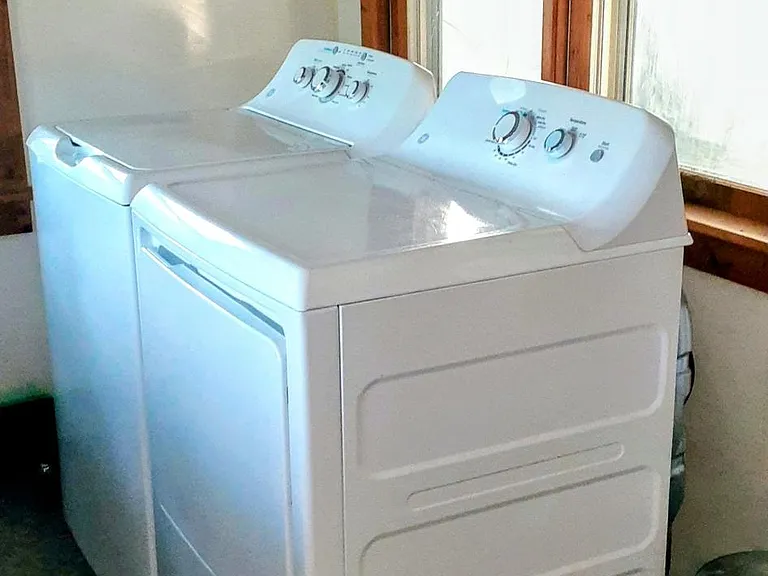 washer dryer in dedicated space 11x11 foot room. Lots of space for ironing and folding.