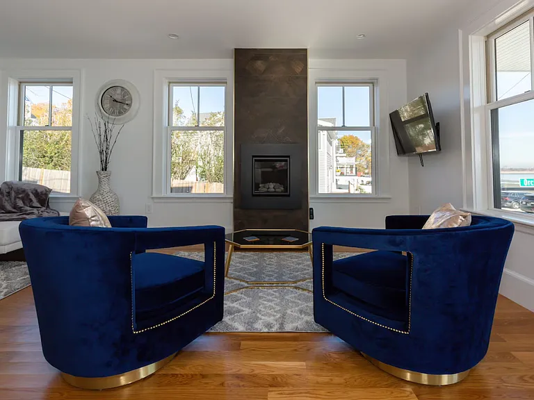 Velvet swivel chairs, gas fireplace with beach stones and Versace tile