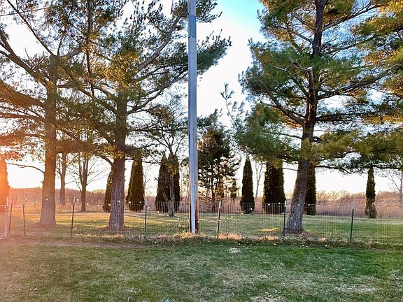 Fenced section of back yard and the view at sunset.