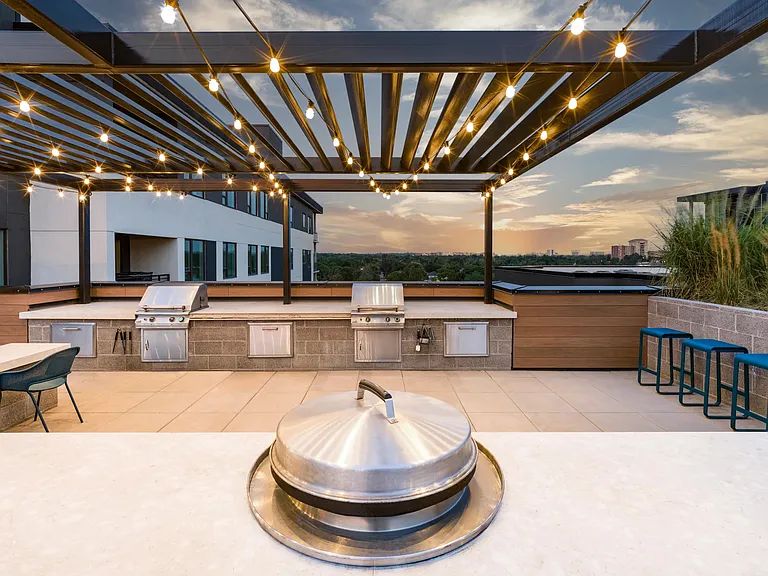 Rooftop grilling area and outdoor kitchen featuring mountain views.