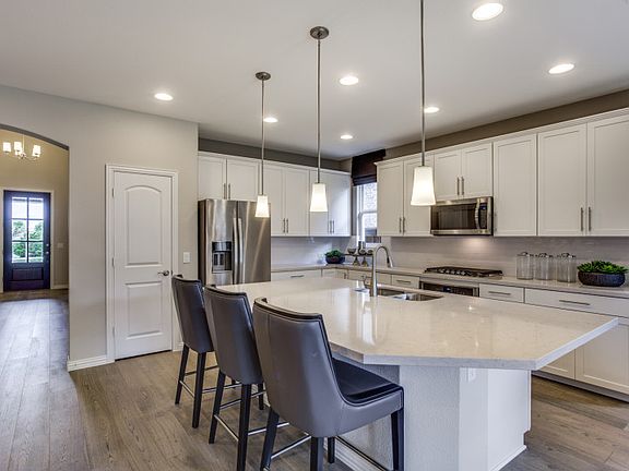 Model Representation - Foyer entry leads to open kitchen with large island