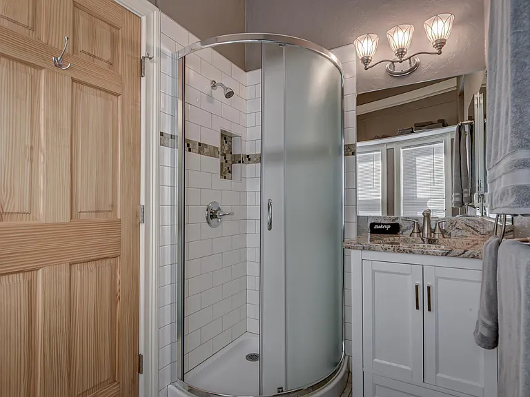 First floor bathroom with compact semi-circular shower.