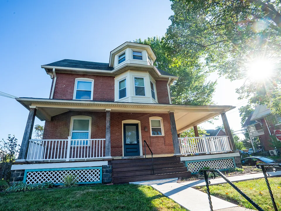 Charming historic brick home with inviting front deck