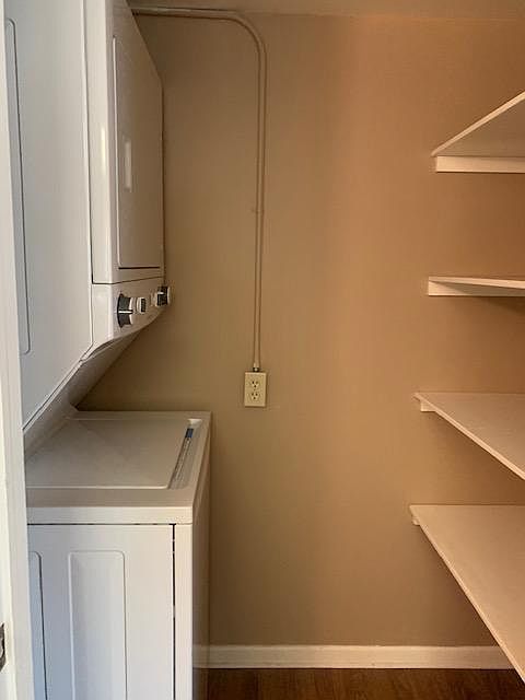 washer & dryer in apartment with shelves
