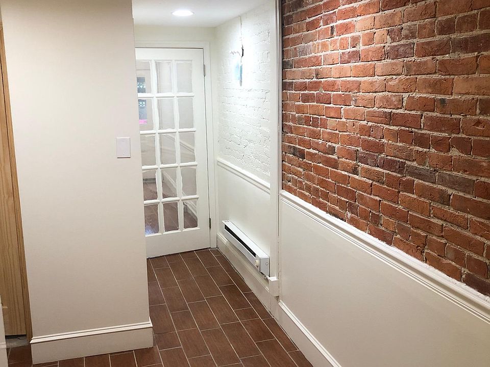 Hallway to bedroom with exposed brick