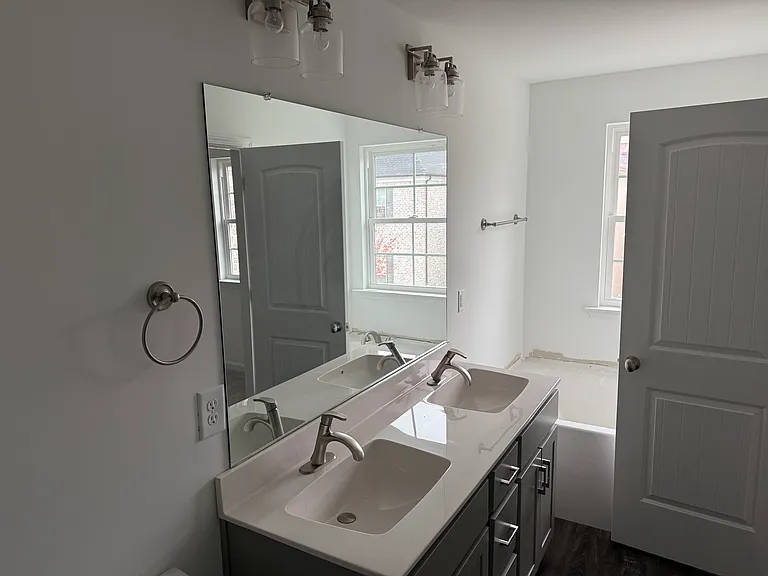 Master bath room with shower/tub combo. Double sink vanities.