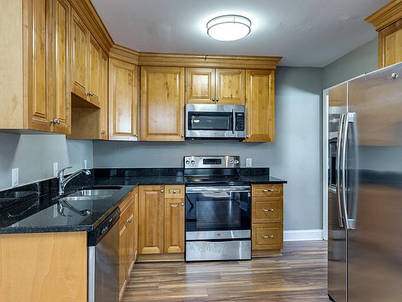 The eat-in kitchen offers new cabinets, granite, appliances