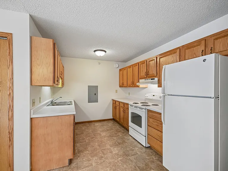 Step into modern living at Mill Pond Apartments with this inviting kitchen, featuring ample cabinet space and contemporary appliances. Perfect for cooking and entertaining, this space is designed for your convenience. Schedule a visit today!