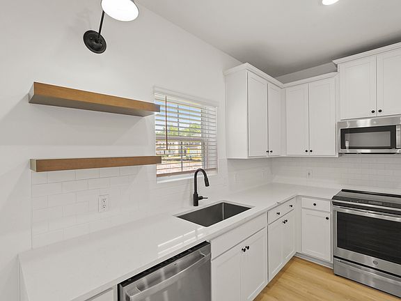 Kitchen with stylish floating shelves