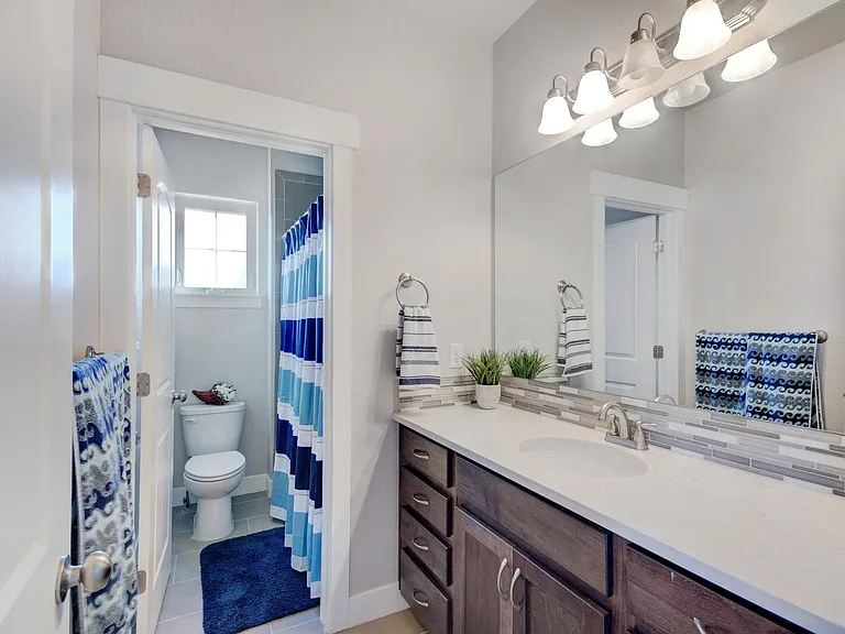 Upstairs Bathroom with Tub and Shower Combo. Quartz Countertop.