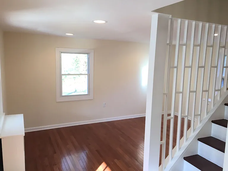 Bright and sunny living room over looking shaded yard