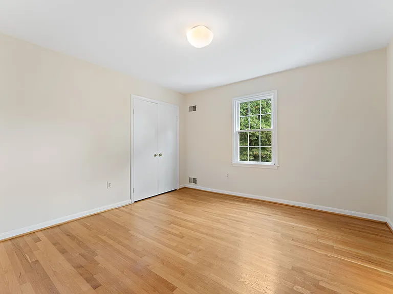 3rd bedroom holds queen-sized bed and desk