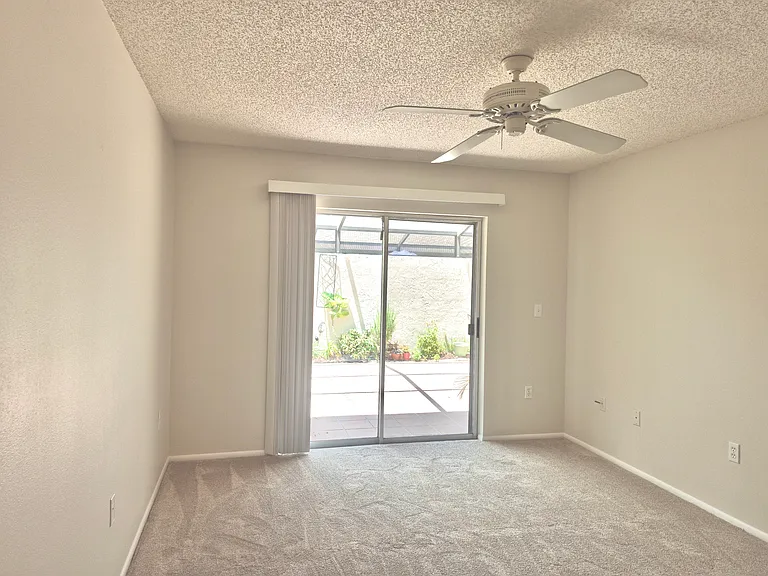 Main bedroom with sliding door to patio.