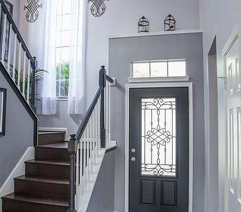 Look at the amount of natural sunlight in this foyer. The new leaded glass front door provides security and decor. The floors are a dark bamboo hardwood.