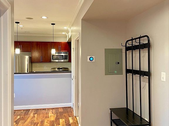 View of hallway featuring next thermostat