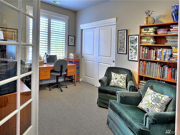 Office/3rd bedroom features double French door entry, plantation shutters and carpet.