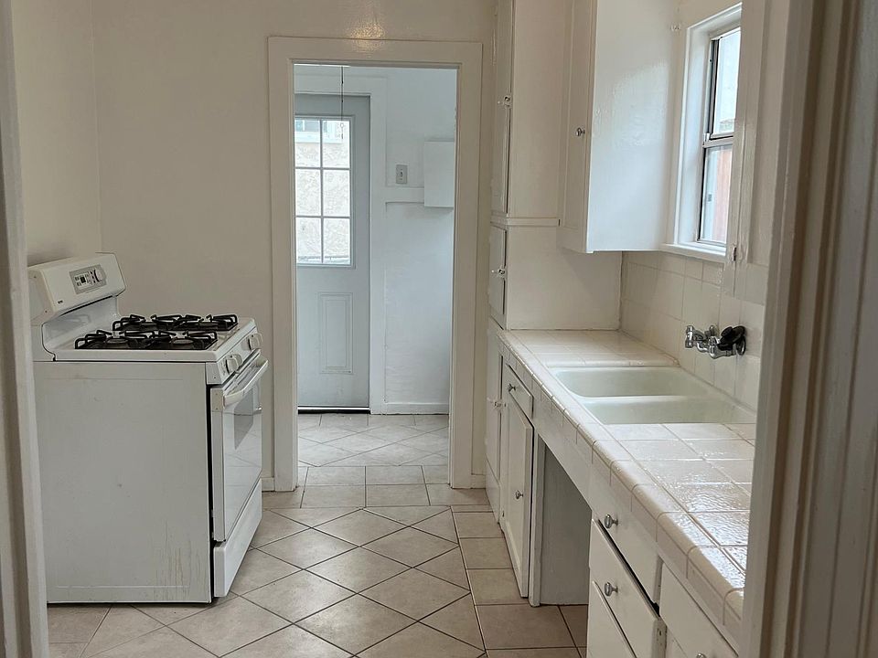 Kitchen looking into Laundry room that has hook-ups.