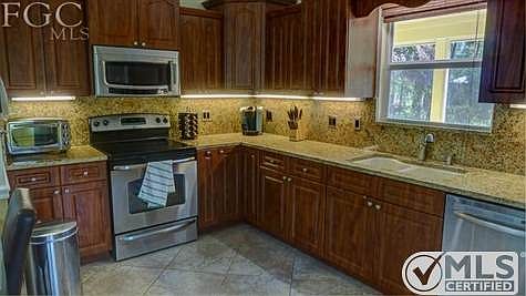 kitchen with granite and stainless steel appliances, fully loaded