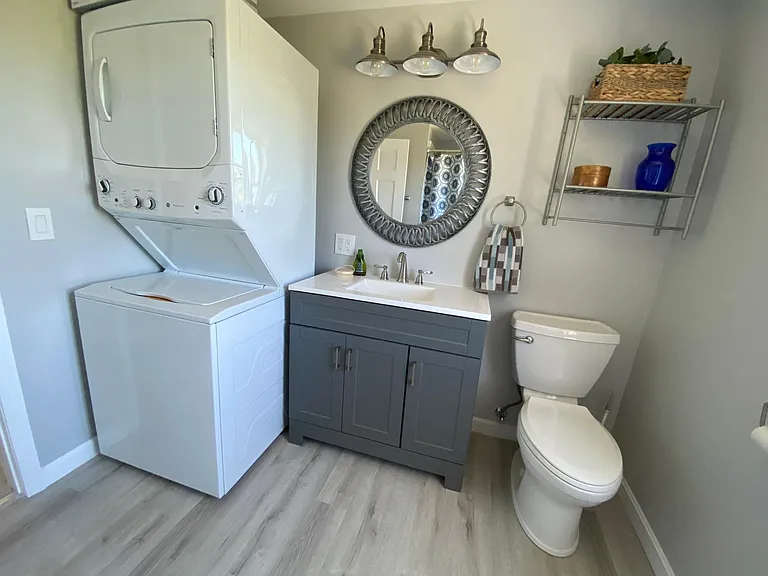 Full bath with stackable washer and dryer
