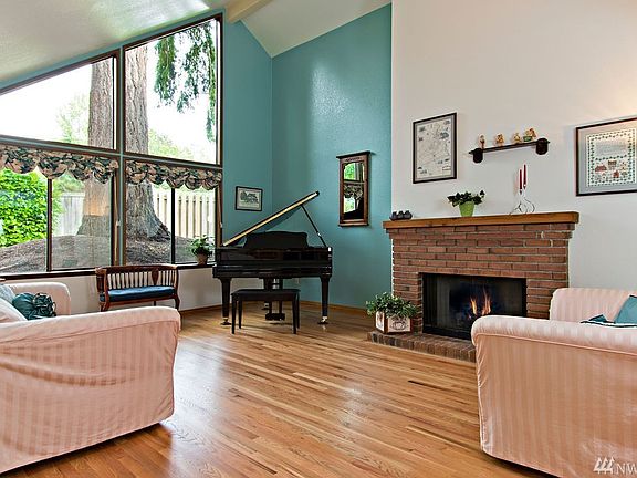 This dramatic living room is a welcome surprise when you enter the front door.  Clean and gleaming oak hardwoods lead you through most of the living spaces and kitchen, with wall to wall carpet in the bedrooms. This is a wood burning fireplace, with a natural gas freestanding enamel stove in the family room.  Although, there is a new A/C unit, the owner also added a whole house fan at the entry that allows you to quickly flush the home of warm air on a hot summer afternoon.  You open windows and allow the fan to replace warmer house air with the cool night air.