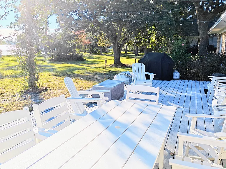 Front patio with fire pit, Weber gas grill, string lights, and plenty of seating.