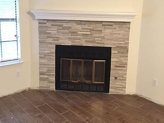 Newly remodeled fireplace in living/greatroom with wood look