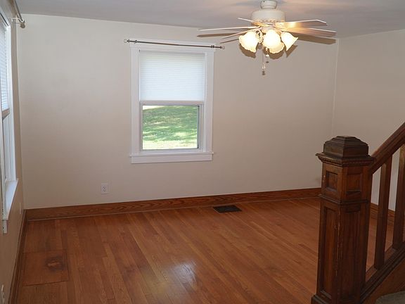 Bright living room with hardwood floors and ceiling fan