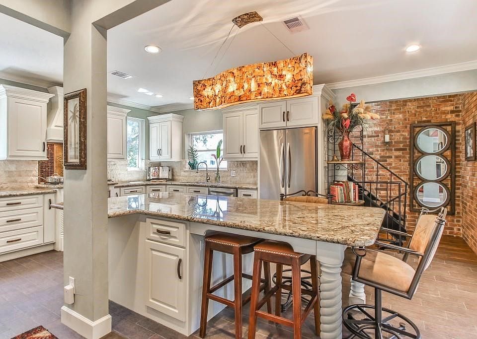 Exquisite granite counter tops, custom cabinetry and stone back splash highlight the awesome chef s kitchen ---- back stairs acc