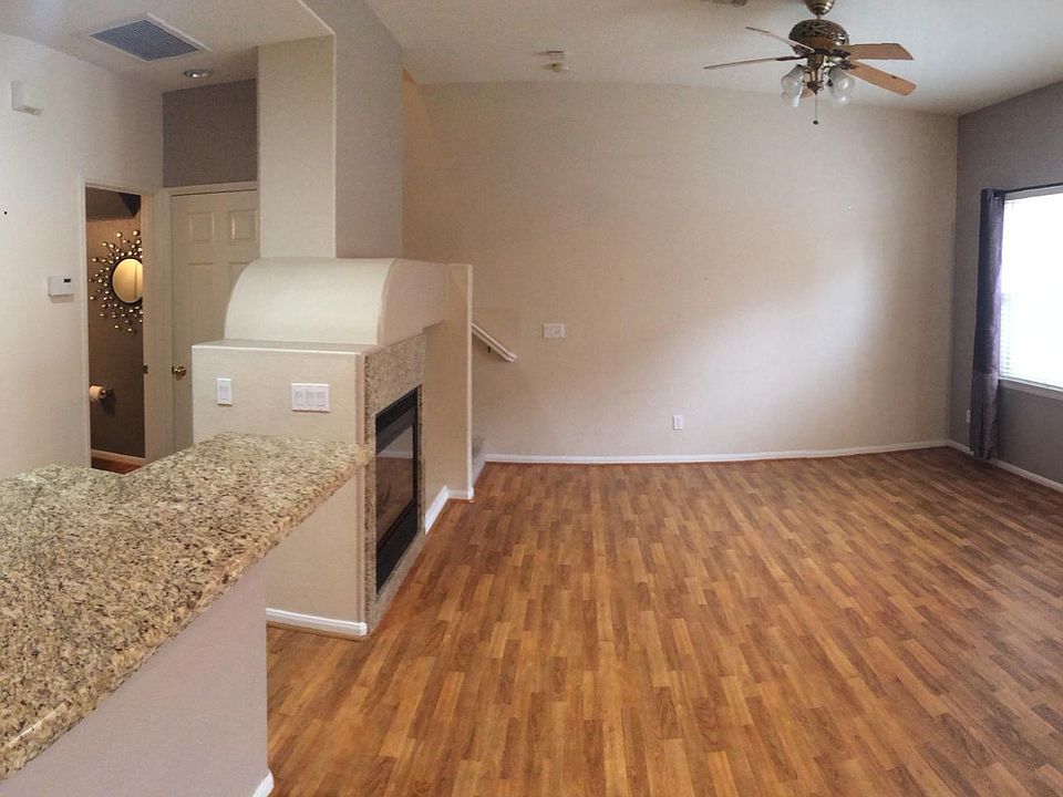 From dining area into living room. Kitchen, half bath and garage to the left.