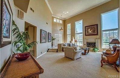 Cozy Fireplace in Living Room and Floor-to-Ceiling windows overl
