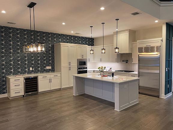 Kitchen with Subzero refrigerator and dining area with wine fridge.