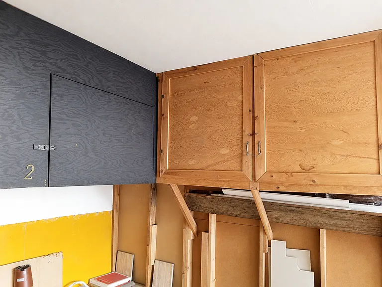 Garage includes built-in storage space and overhead cabinet areas.