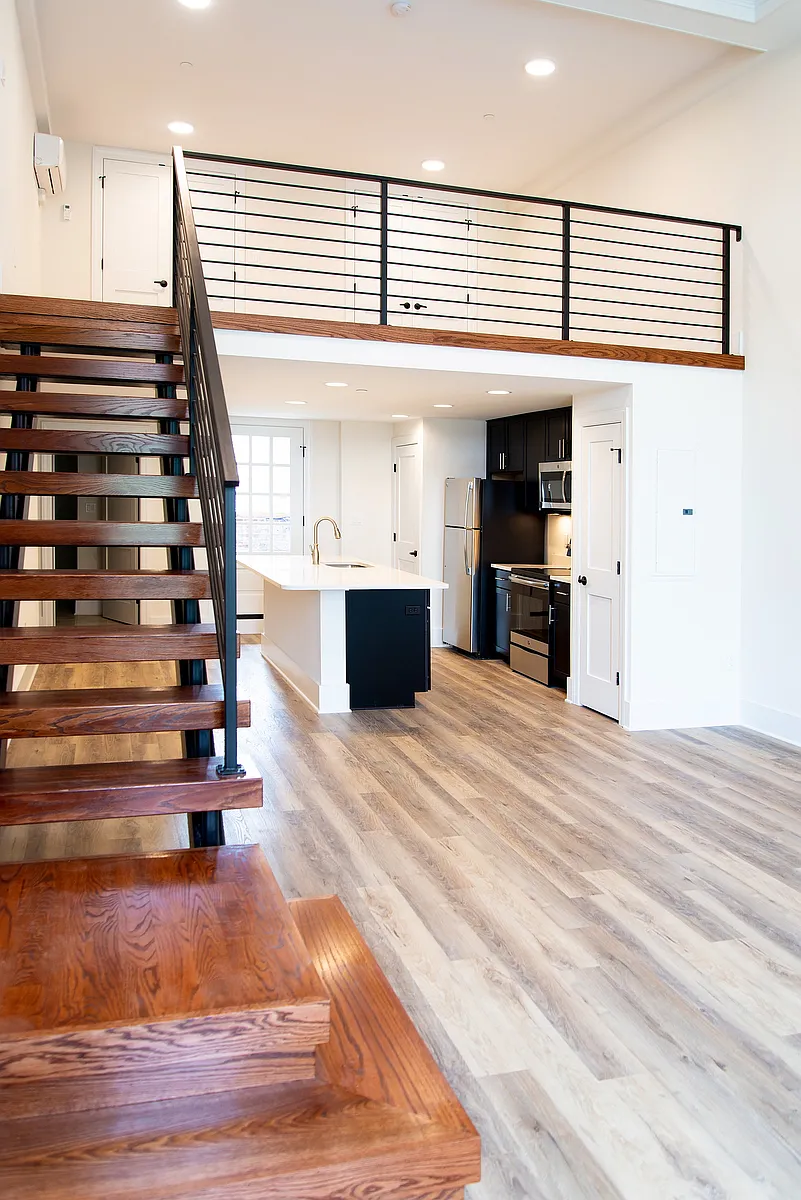 Step into this chic urban loft, featuring a contemporary kitchen and elegant wooden accents. - 4 E Church St