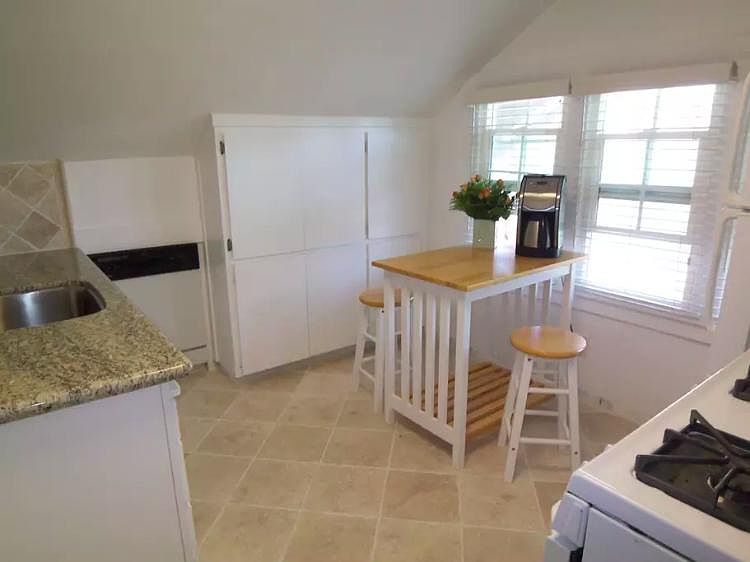Gourmet kitchen with granite, travertine floors, tumbled tra