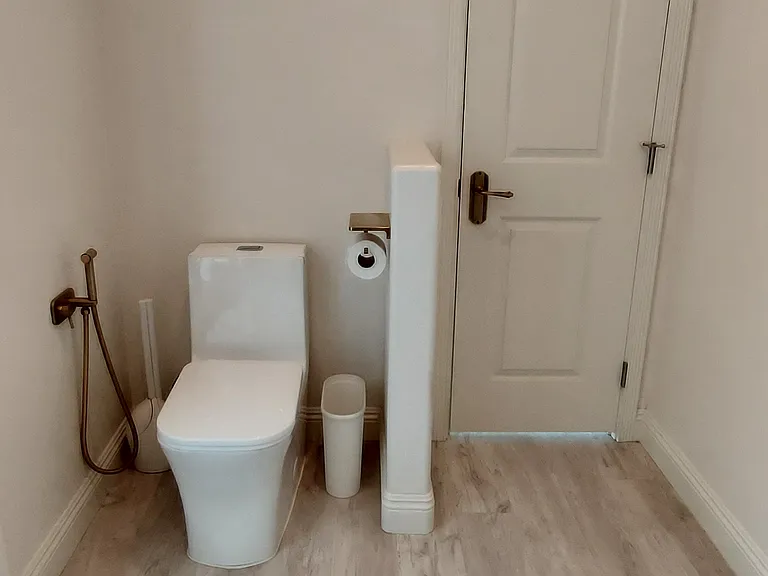 Shattaf next to toilet (Middle Eastern bidet with hot and cold water)