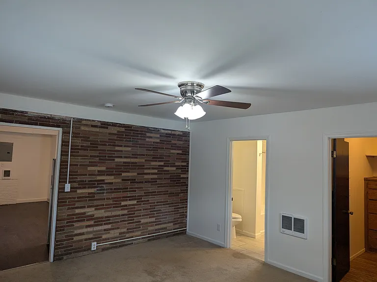 Bedroom facing living/kitchen, bath, closet