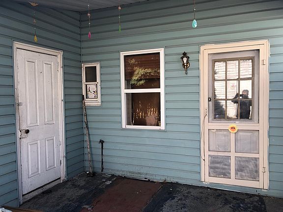 Entrance to Apartment with covered patio! And storage shed for yard tools!