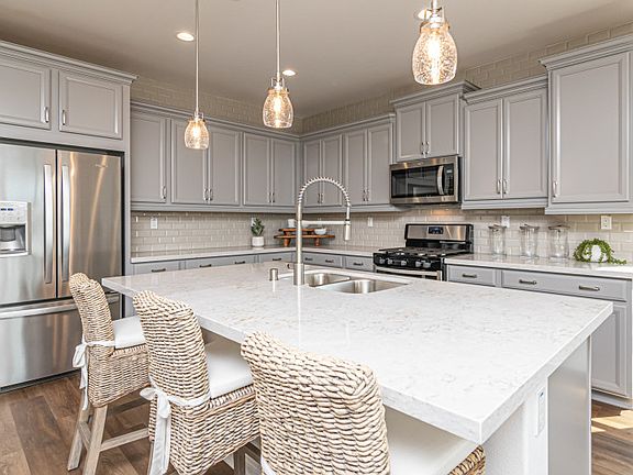 The Exeter designer kitchen shown with a large kitchen island and accent lighting.