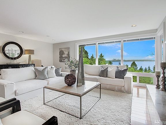 Another angle of the living room which shows the cozy, gas-lit fireplace, with raised hearth.  The living room is open to the dining room which makes entertaining so easy.  Room for the grand piano as well.