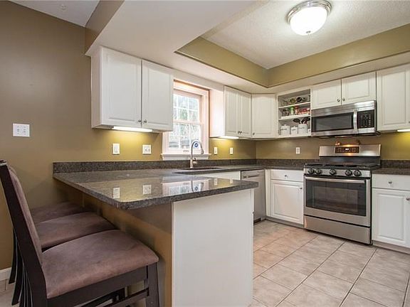 A breakfast bar with seating adds additional dining space to the kitchen.