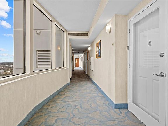 Hallway leading to your front door. Your elevator is just a few doors down. Views looking west over Lake Holly & Norfolk Ave. 